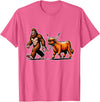 Bigfoot And Scottish Highland Cow Walking Humor Bigfoot Takes Scottish Highland Cow for a Walk T-Shirt - Pink Heather