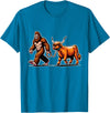 Bigfoot And Scottish Highland Cow Walking Humor Bigfoot Takes Scottish Highland Cow for a Walk T-Shirt - Sapphire Blue